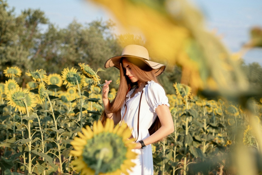 A woman standing in a field of sunflowers