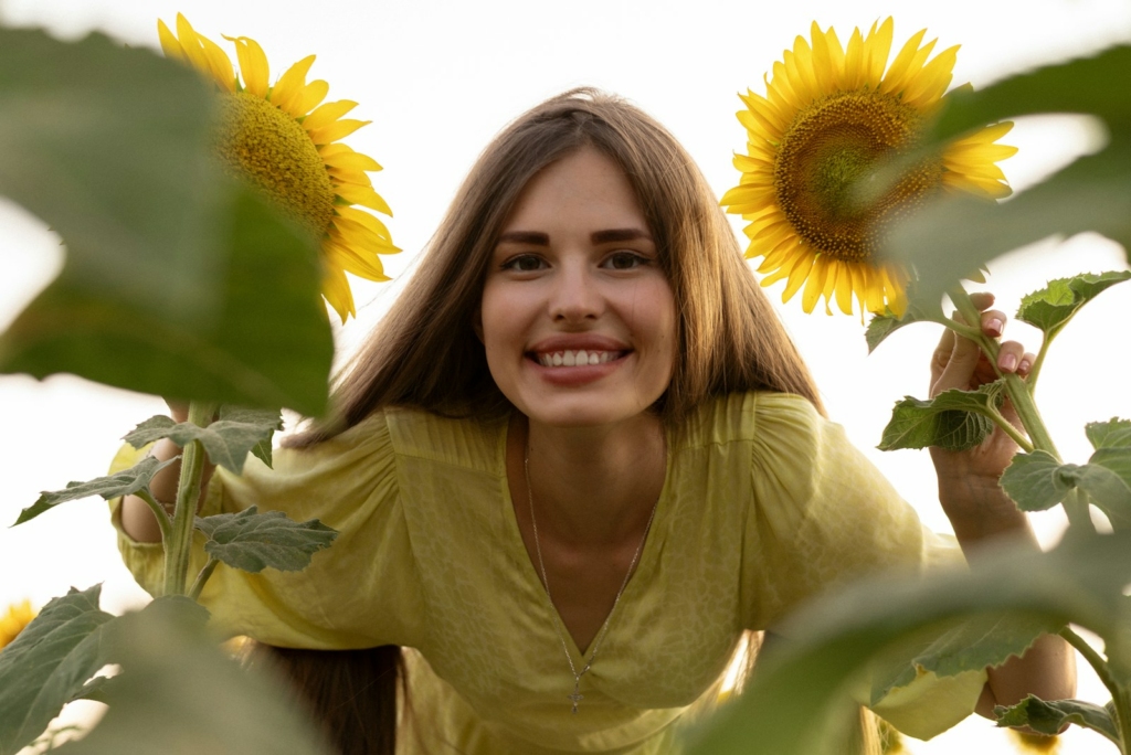 A woman standing in a field of sunflowers