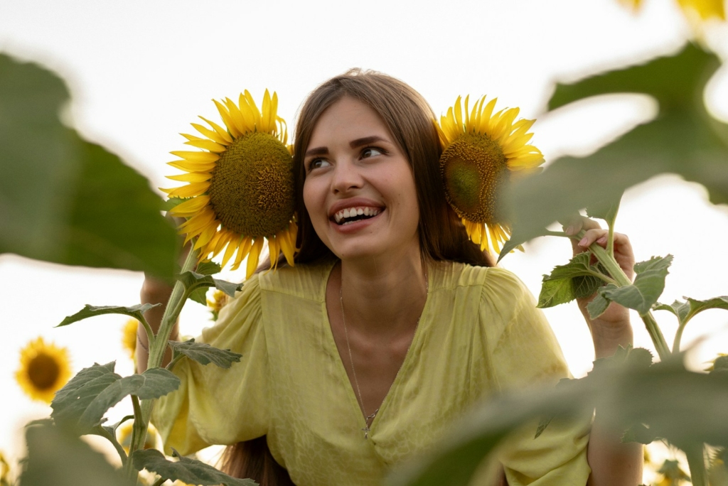 A woman standing in a field of sunflowers